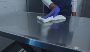 Wiping dirt off exam table with towel